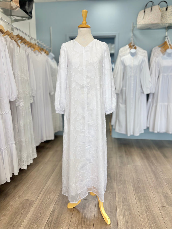 Long white dress with floral appliques and zipper front.