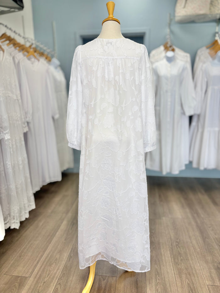 Back of long white dress with floral appliques.