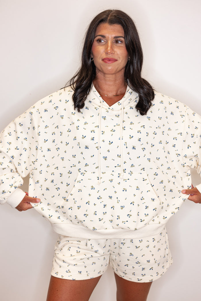 Women's cream french terry knit hooded top with blue floral print by Wishlist showing relaxed fit