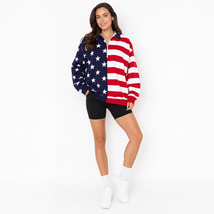 American flag sweatshirt styled with casual bottoms, showing the star and stripe design and half zip detail for women's wear.