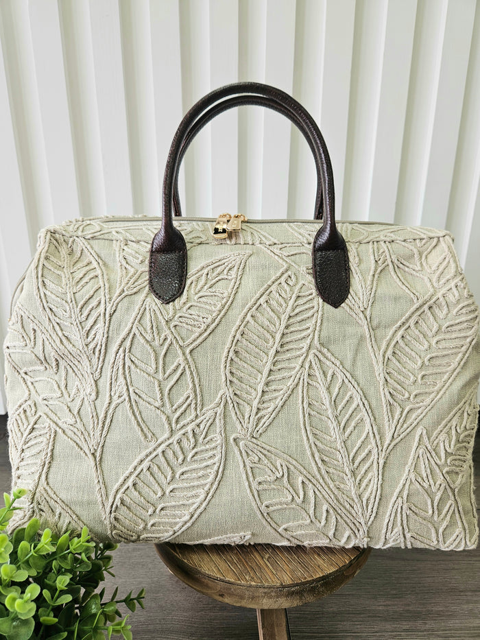 Carpet bag with leaf design.