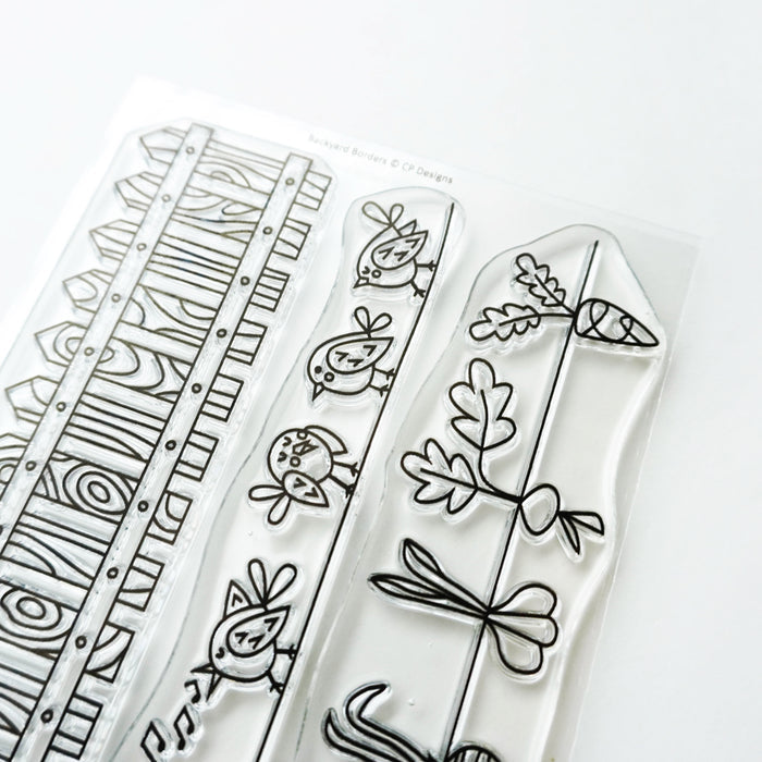 Catherine Pooler - Stamp - Backyard Borders. Color the images in the Backyard Borders Stamp Set as a focal point on your card, or use them as a subtle background. The Backyard Borders Stamp set includes a row of fence posts, singing birds, and planted veggies. Available at Away in Bowmanville Ontario Canada.