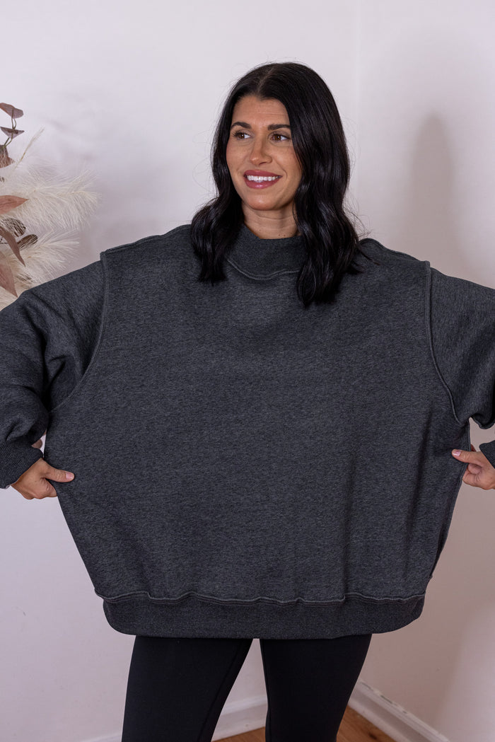 Women's charcoal reversible mock neck sweatshirt by Bucketlist showing oversized fit
