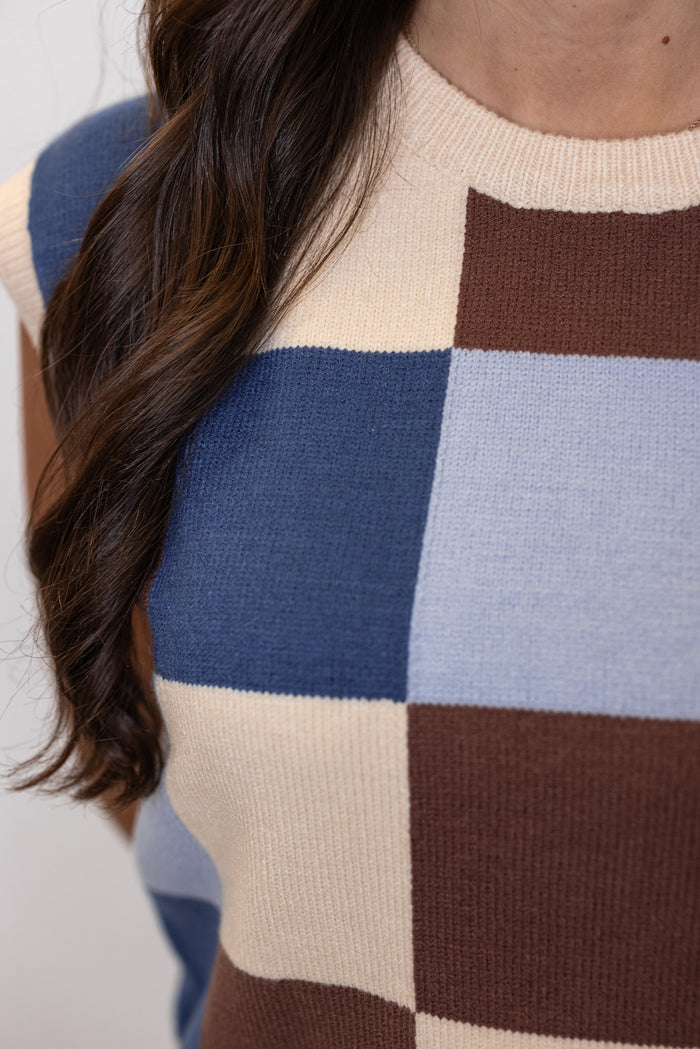 Women's blue, brown and cream checkered knit top with capped sleeves by ee:some showing up close view of checkered pattern