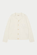 A long-sleeved off white shirt with a ribbed revere collar, crochet knit fabric, and a front left chest patch pocket with an embroidered emblem.