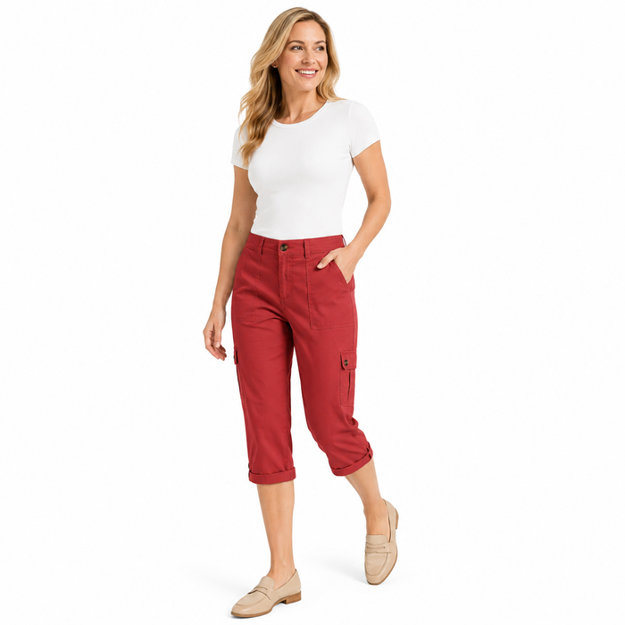 A woman modeling a pair of red cropped cargo pants, styled with a white t-shirt and beige loafers, against a plain white background.