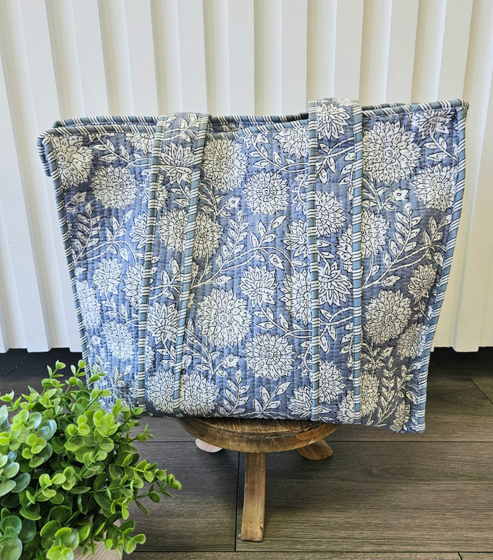 blue floral quilted tote bag on stool