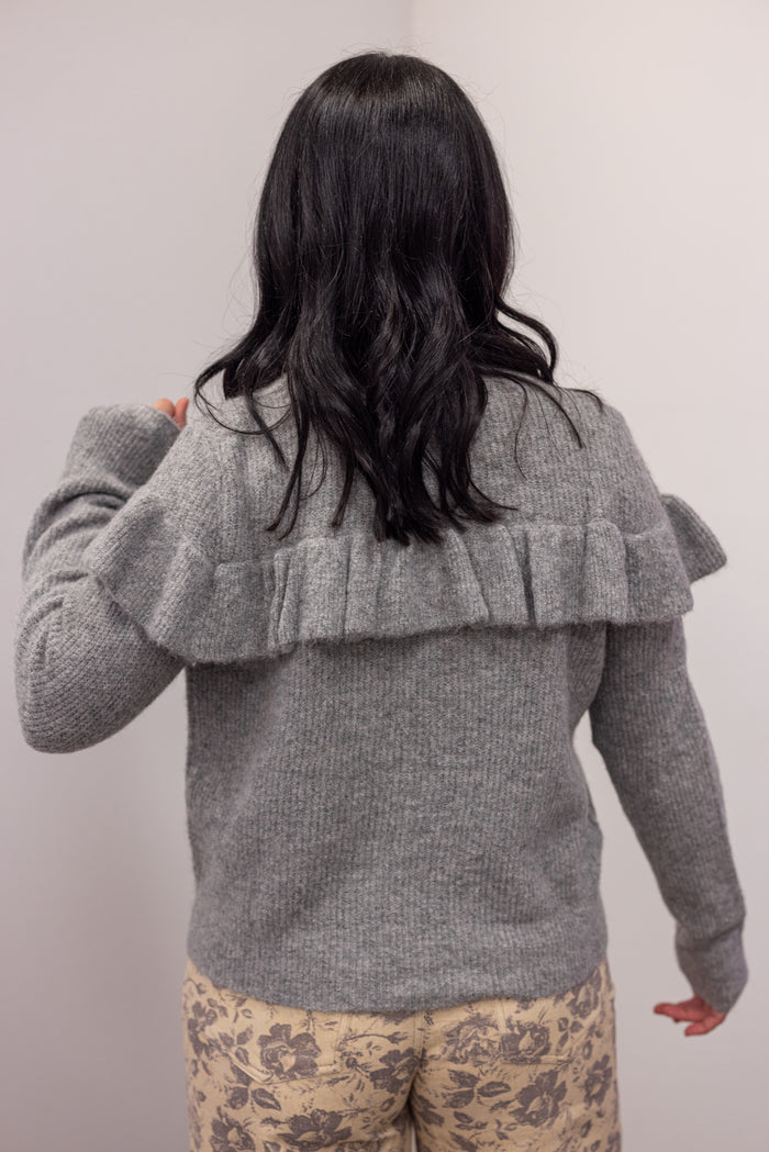 Women's grey knit sweater with a ruffle across the front chest and back shoulders by Wishlist showing up close back view