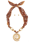 Brown patterned scarf necklace with gold spiral pendant and pearl-like beads