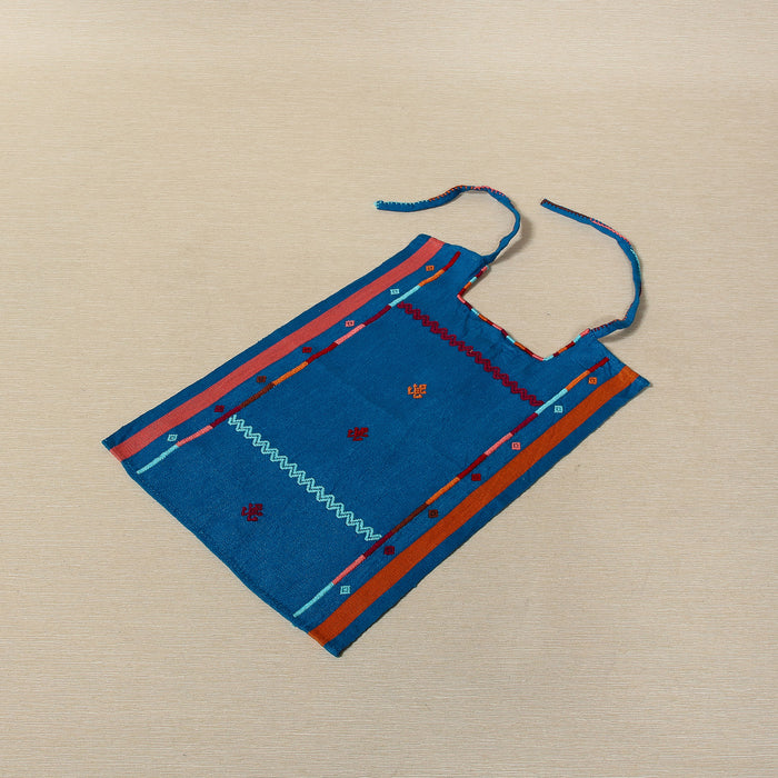 Handwoven cotton bib with embroidered borders and frog motifs, Oaxaca Mexico