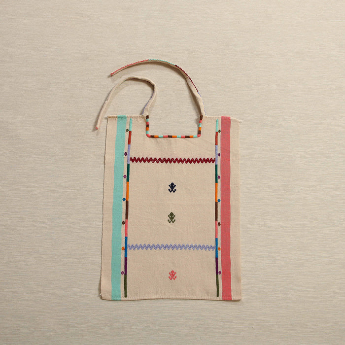 Handwoven cotton bib with embroidered borders and frog motifs, Oaxaca Mexico