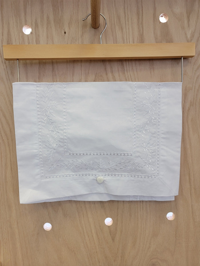 White envelope with floral embroidery.