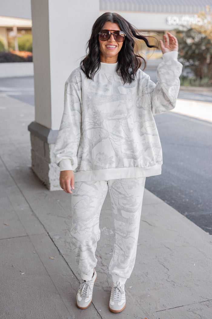 Women's grey snow camo joggers by BucketList shown with matching sweatshirt