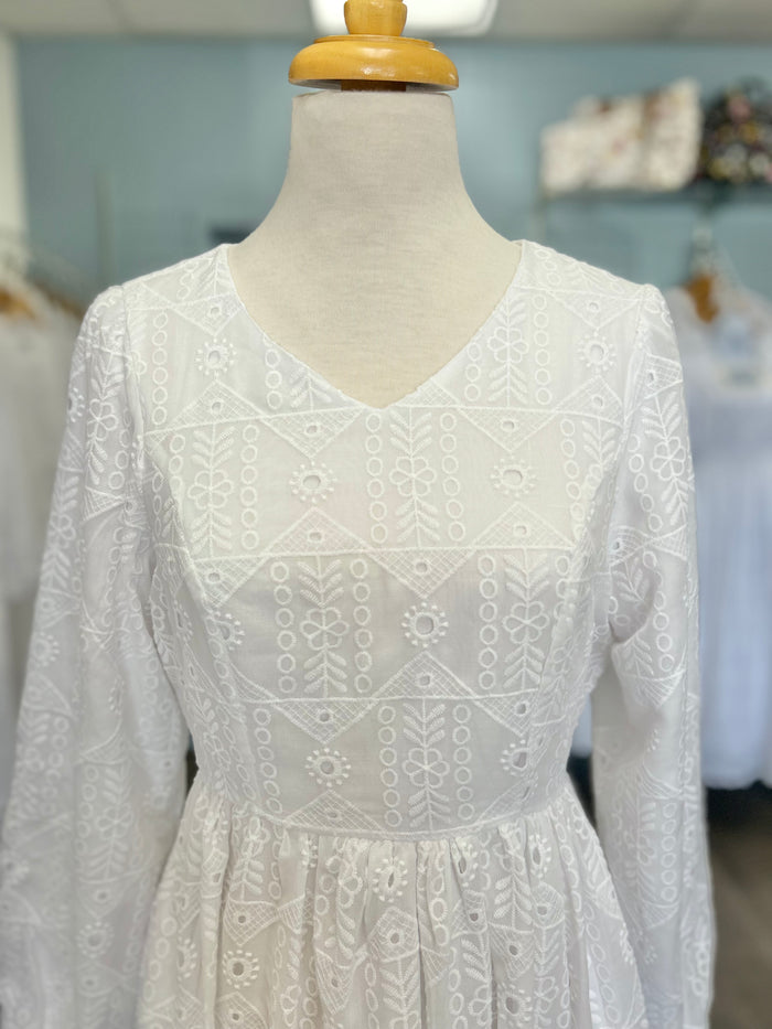 White eyelet dress with V-neck.