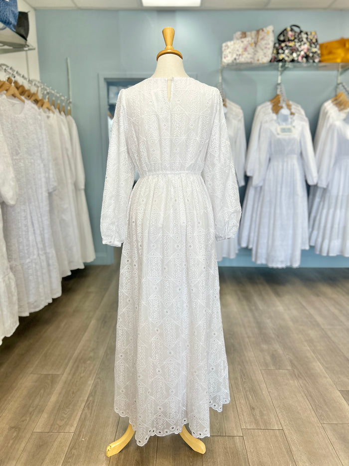 White eyelet dress with button hole closure.