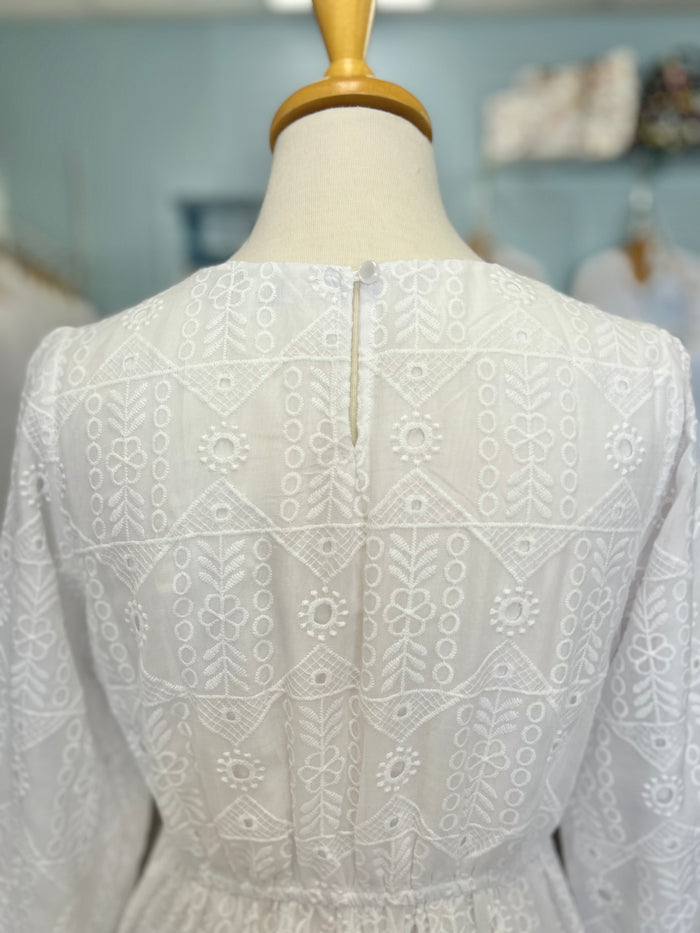 White eyelet dress with button hole closure.