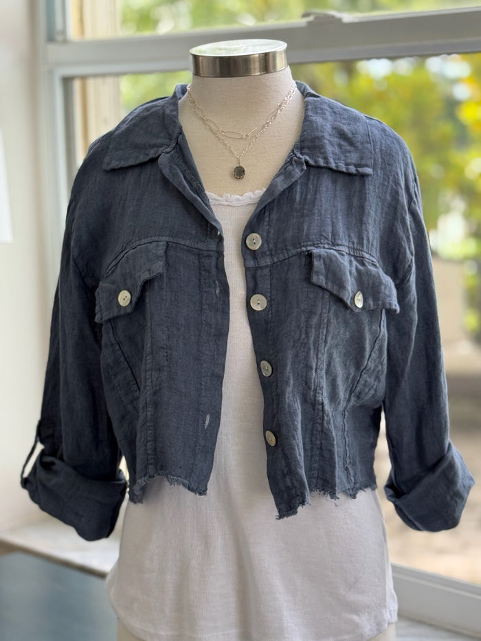 Chambray linen jacket layered over white tank and styled with silver jewelry