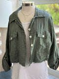 Olive linen jacket layered over a white tank