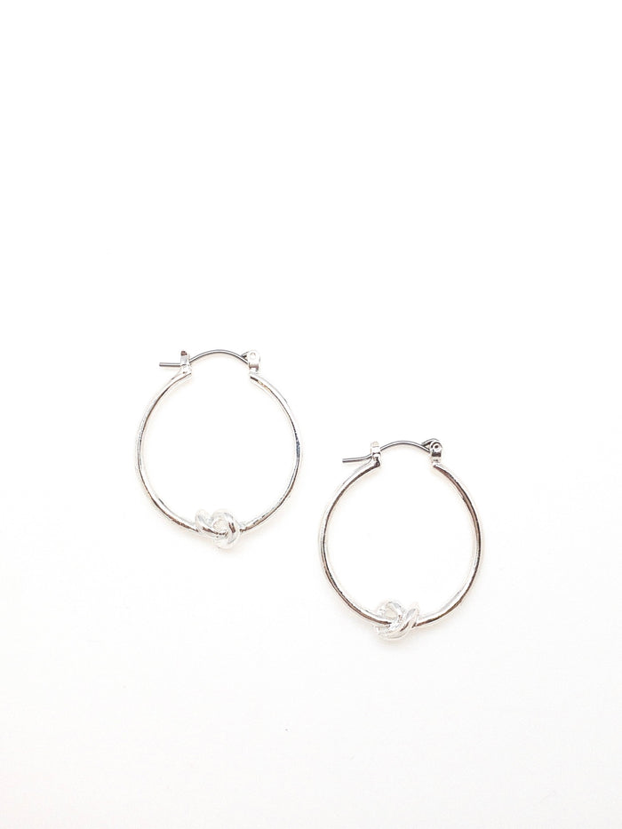 Silver Kelly hoop earrings with a knot detail in the bottom center of earring