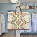 Tote bag with gold floral print.