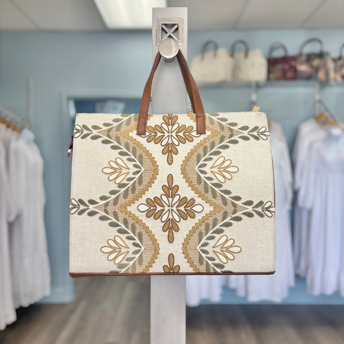 Tote bag with gold floral print.