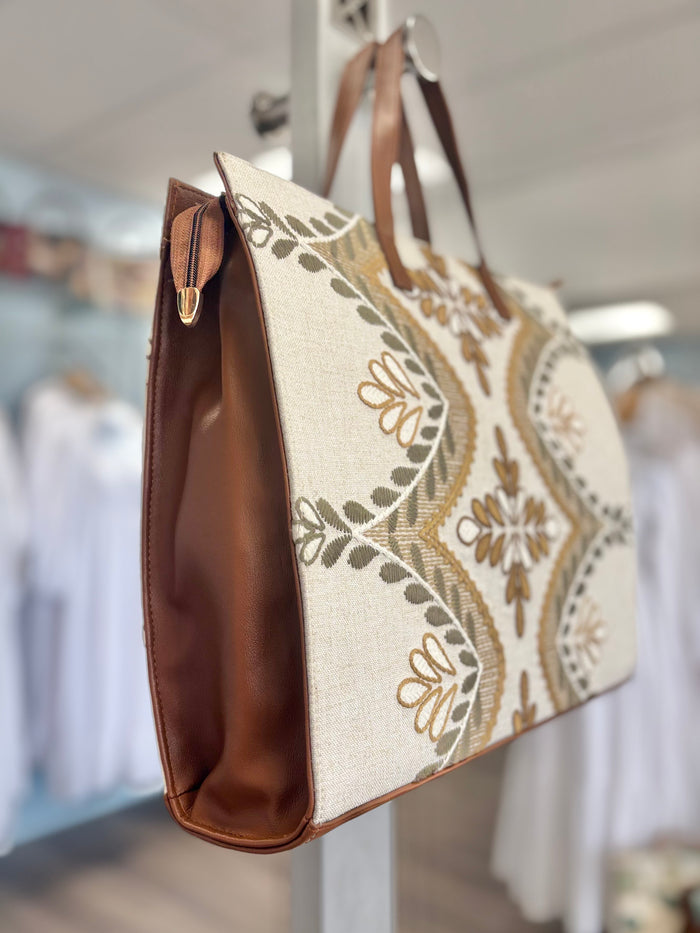 Tote bag with gold floral print.