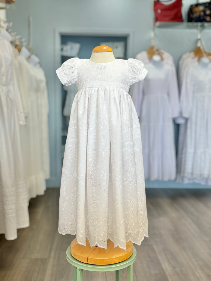 Long white baby gown with rosette and eyelet lace.