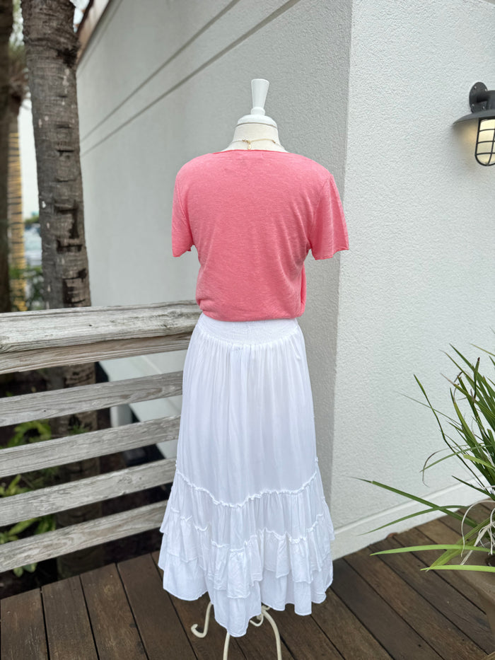 White skirt paired with a coral V neck tee