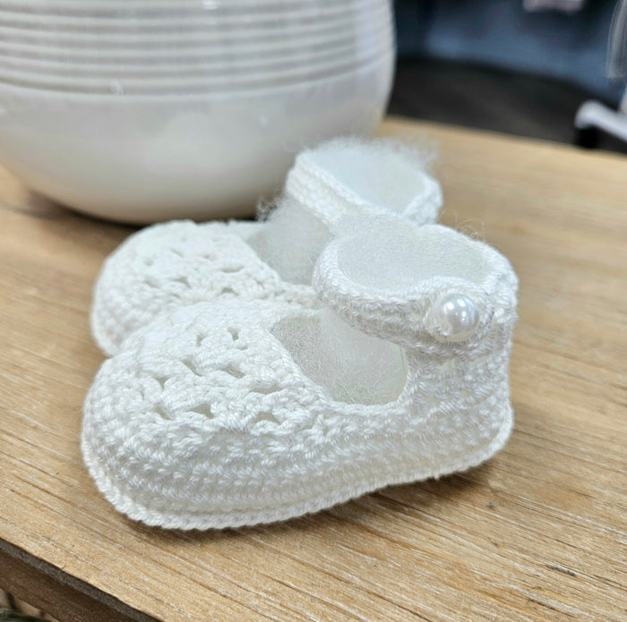 Baby booties with pearl button.