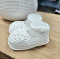 Baby booties with pearl button.