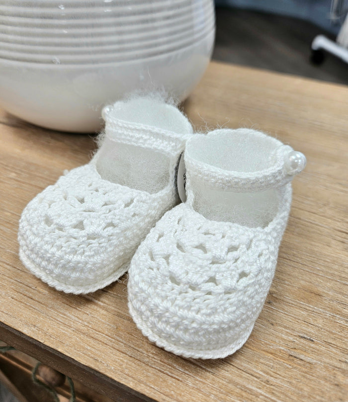 Baby booties with pearl button.