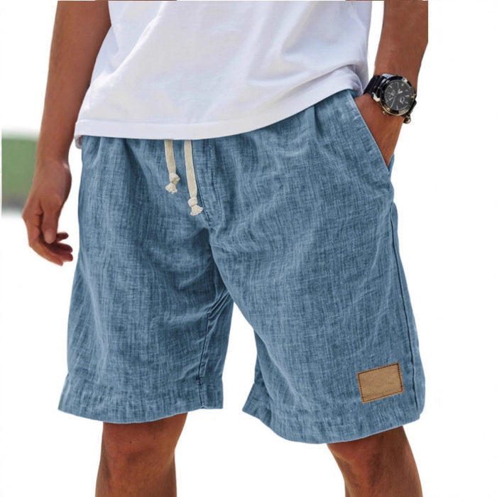 Flat lay of gray-white cropped shorts with drawstring waist and vintage-inspired relaxed summer shape.