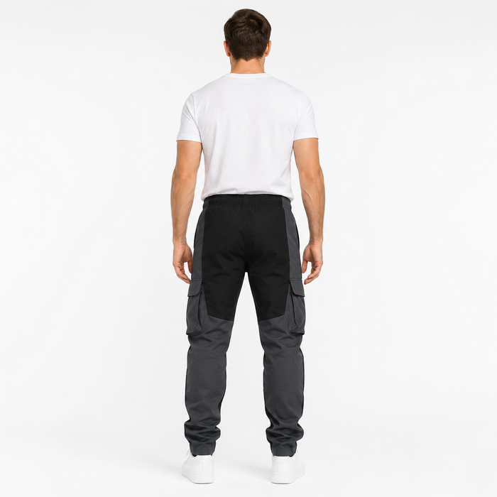 Men's black loose fit cargo trousers back view with charcoal leg panels and tapered fit
