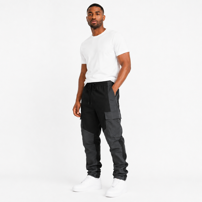 Men's black multi-pocket cargo trousers three-quarter view with stitched charcoal panels