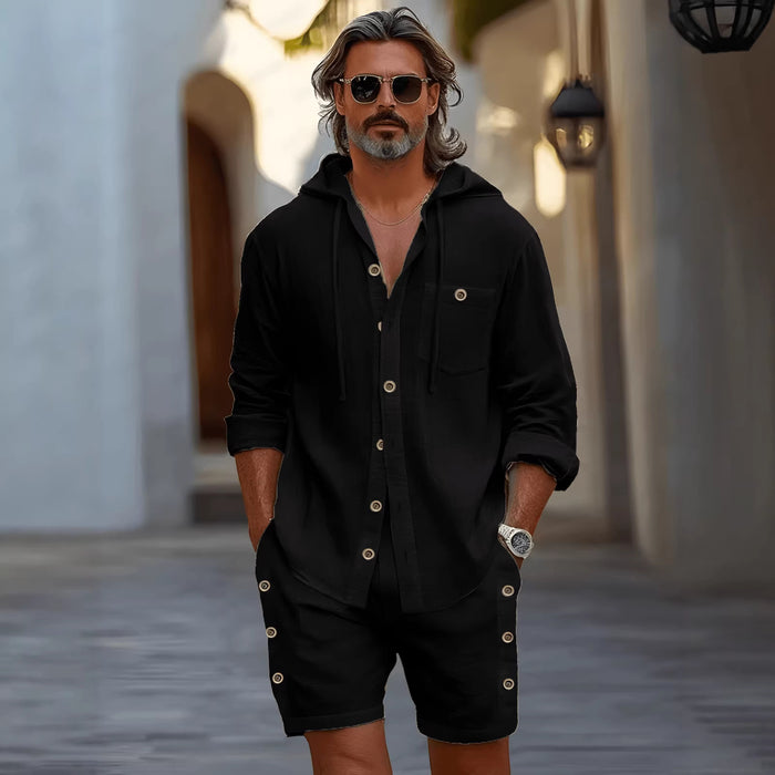 Man wearing a black outfit with sunglasses in an outdoor setting