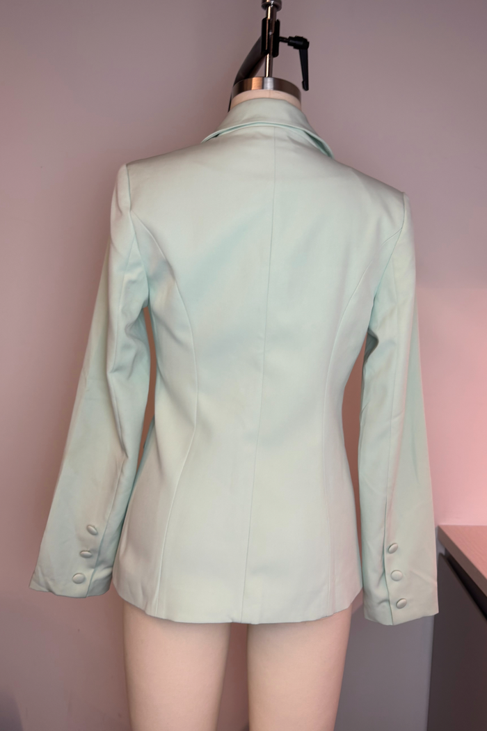Light green blazer on a mannequin against a plain background