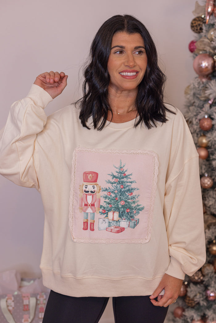 Women's cream corduroy patch sweatshirt with a nutcracker and Christmas tree by Peach Love California
