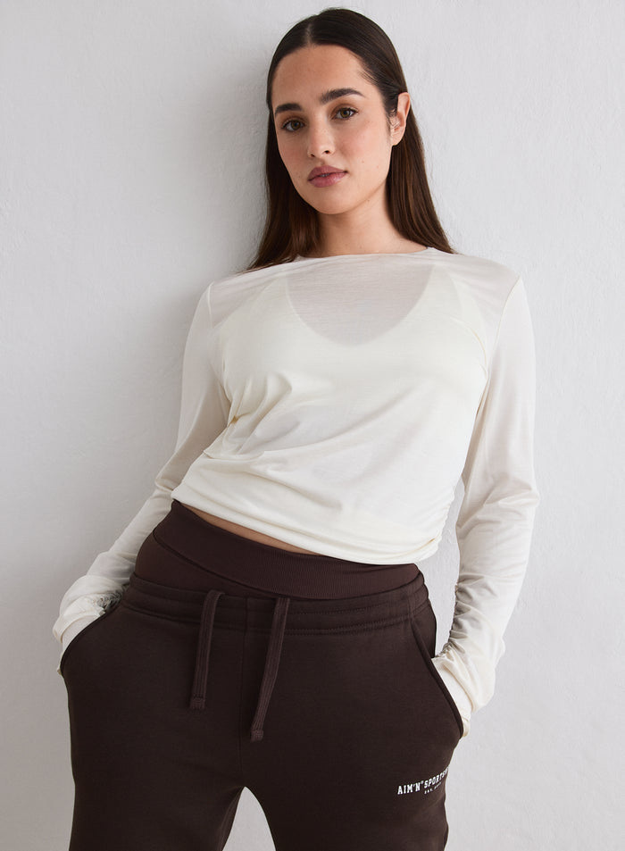 Malli yllään Off White Luminous Draped Long Sleeve ja ruskeat collegehousut [L-174cm]