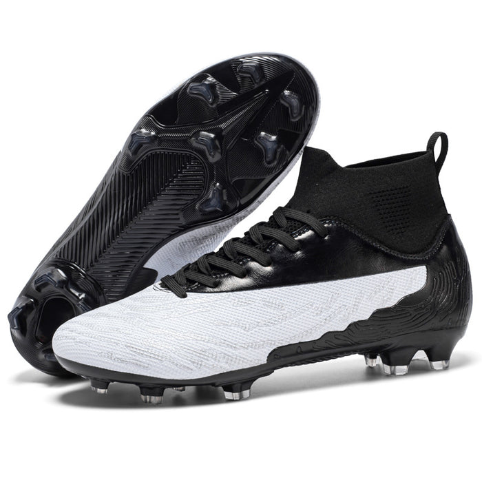 Athlete wearing black and white soccer cleats mid-sprint on outdoor grass training ground