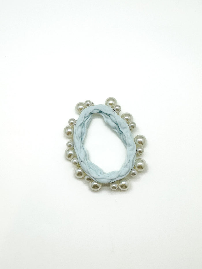 Marble-patterned earring with pearl-like beads on a white background