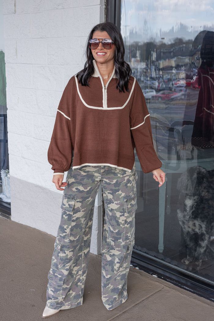 Women's brown knit sweater with cream trim and a zipper bodice by She + Sky showing full front view