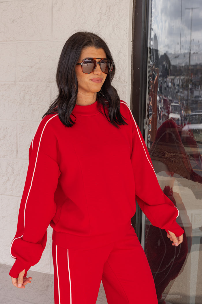 Women's red scuba knit mock neck top by Rae Mode showing up close slight side view