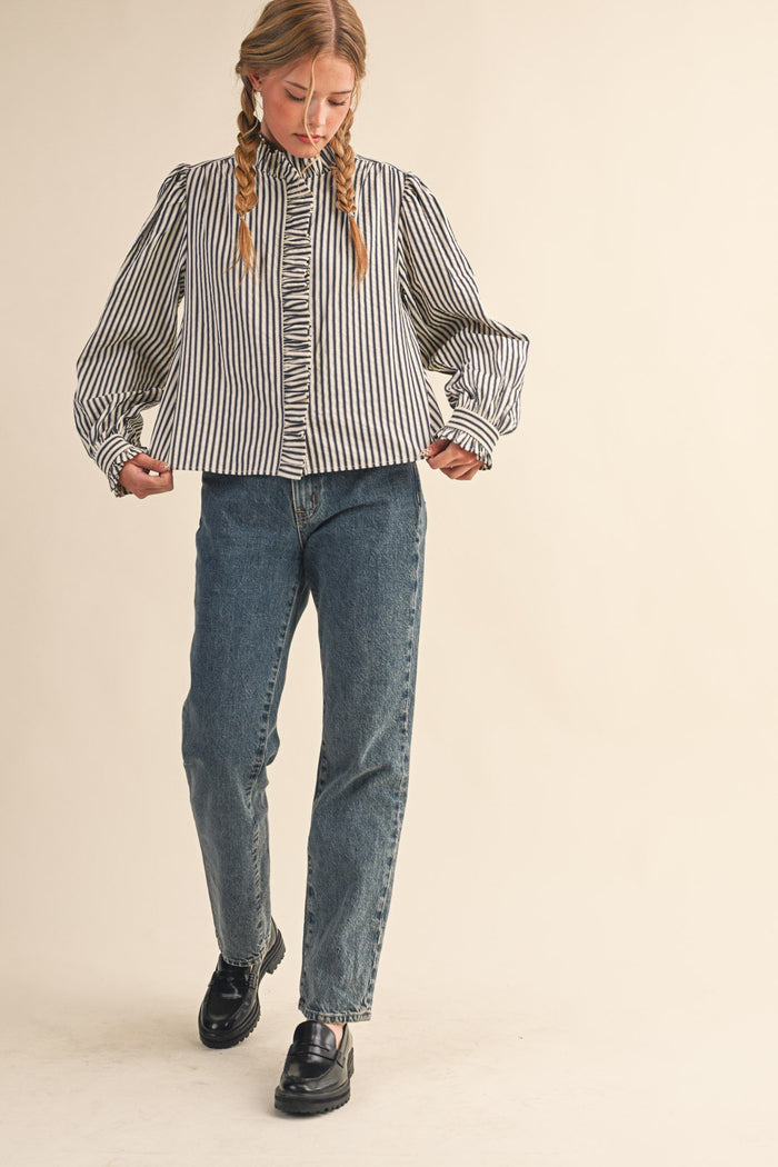 Women's black and cream striped button front top with ruffle trim details by &merci showing view of shirt width