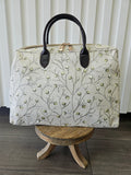 Beige zipper top purse with sage blossom design.