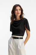 Close-up of scoop neckline detail on black polyester puff sleeve women's top, solid color fabric