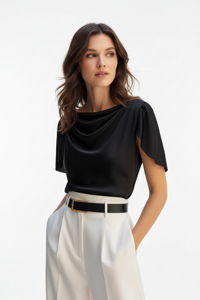 Close-up of scoop neckline detail on black polyester puff sleeve women's top, solid color fabric