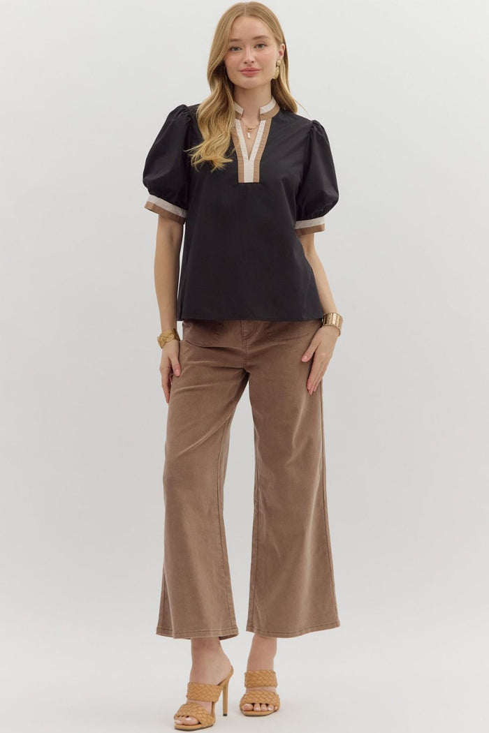 Women's black puff sleeve top with tan and cream trim by Entro showing full front view
