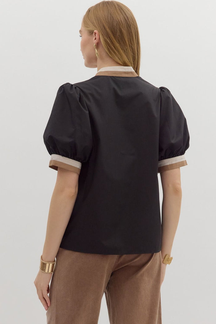 Women's black puff sleeve top with tan and cream trim by Entro showing back view