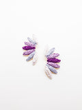 A pair of fan-like earrings with layered shades of purple, featuring a textured design.