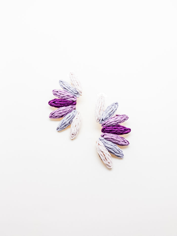 A pair of fan-like earrings with layered shades of purple, featuring a textured design.